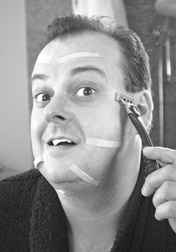 man shaving in front of the mirror