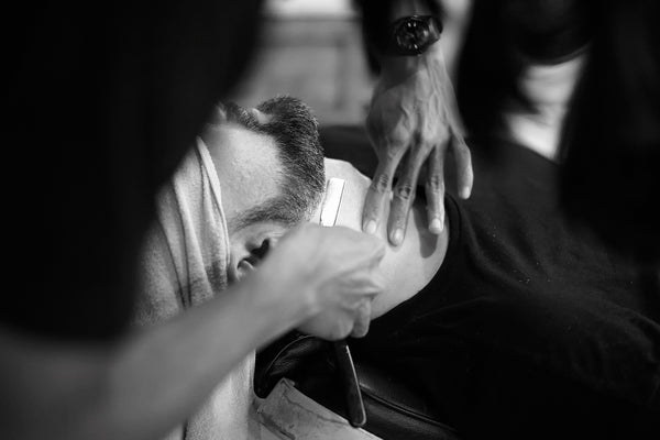 barber trimming a beard